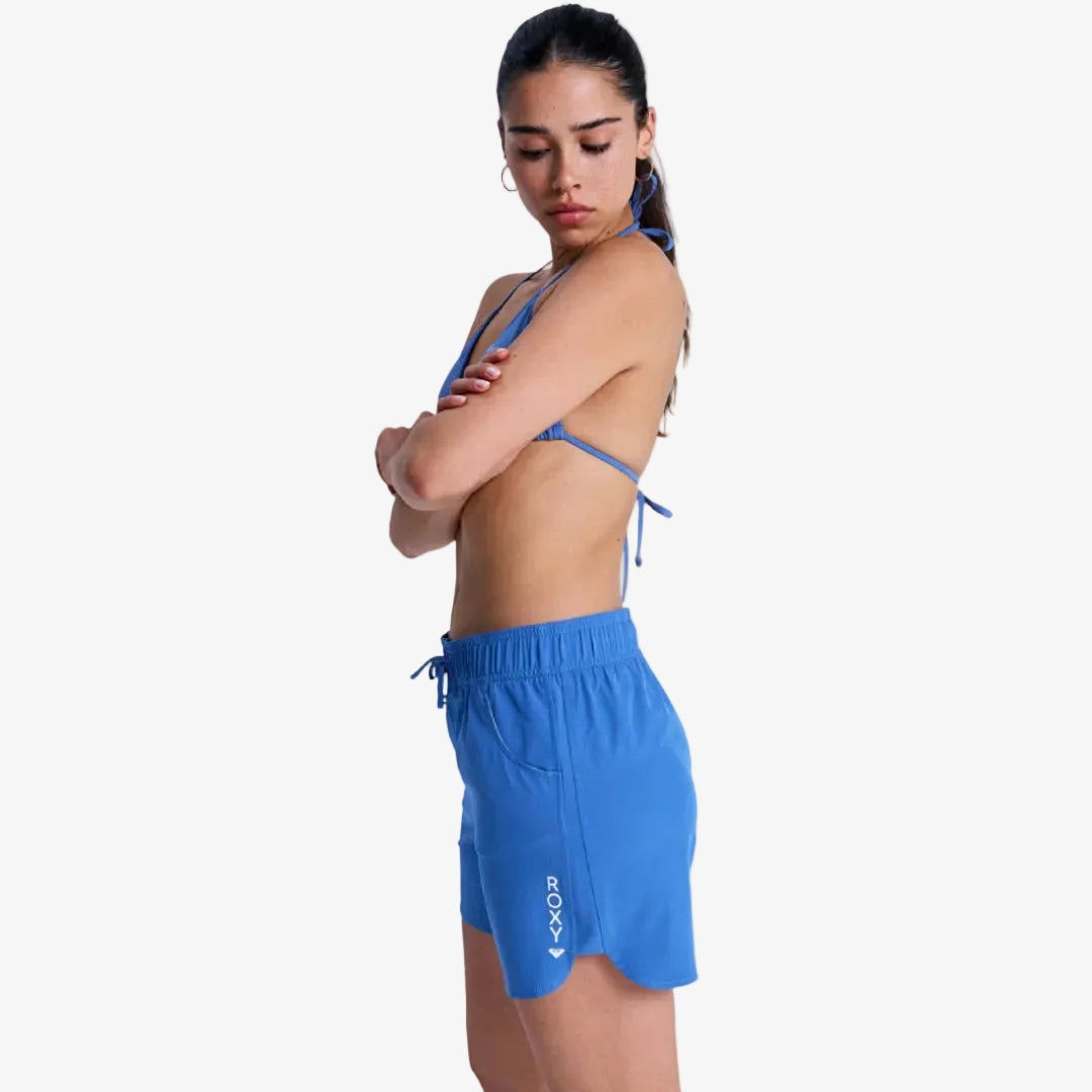 Woman wearing a blue sports outfit with a white background